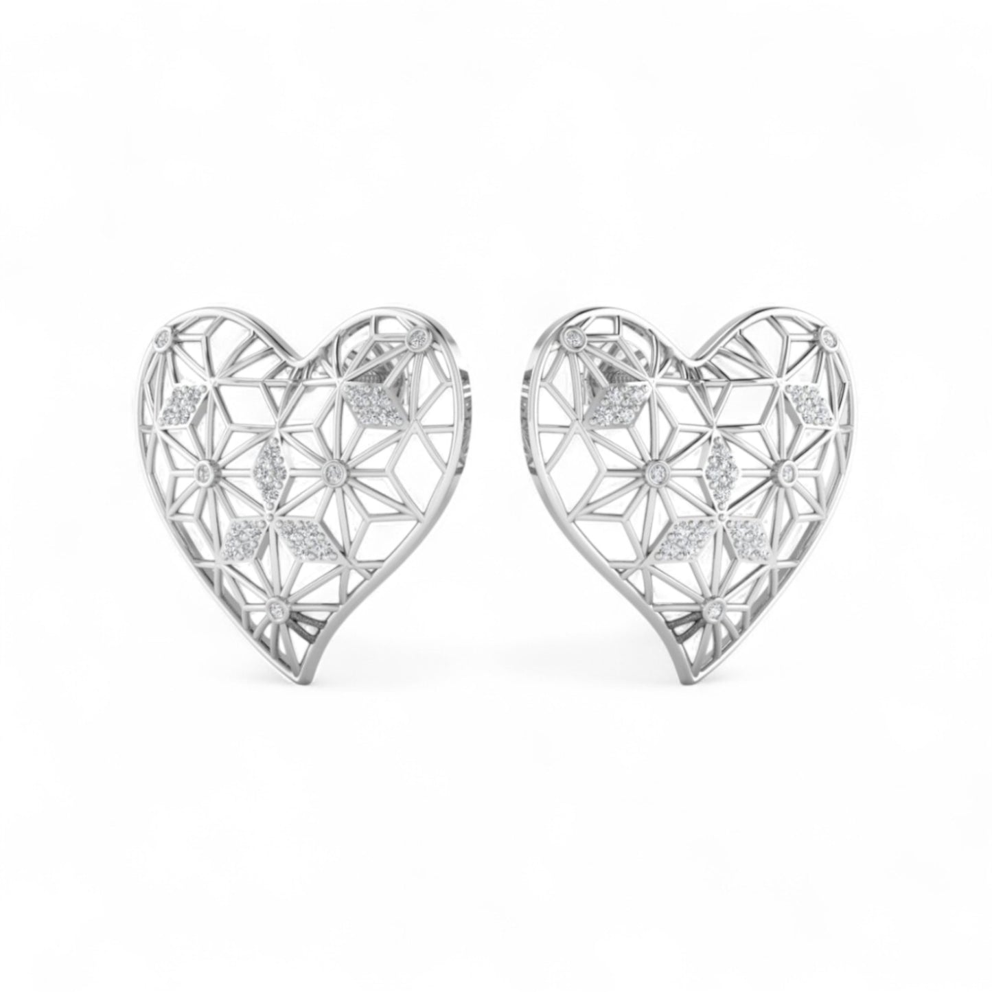 Heart-shaped silver earrings with intricate designs on a white background