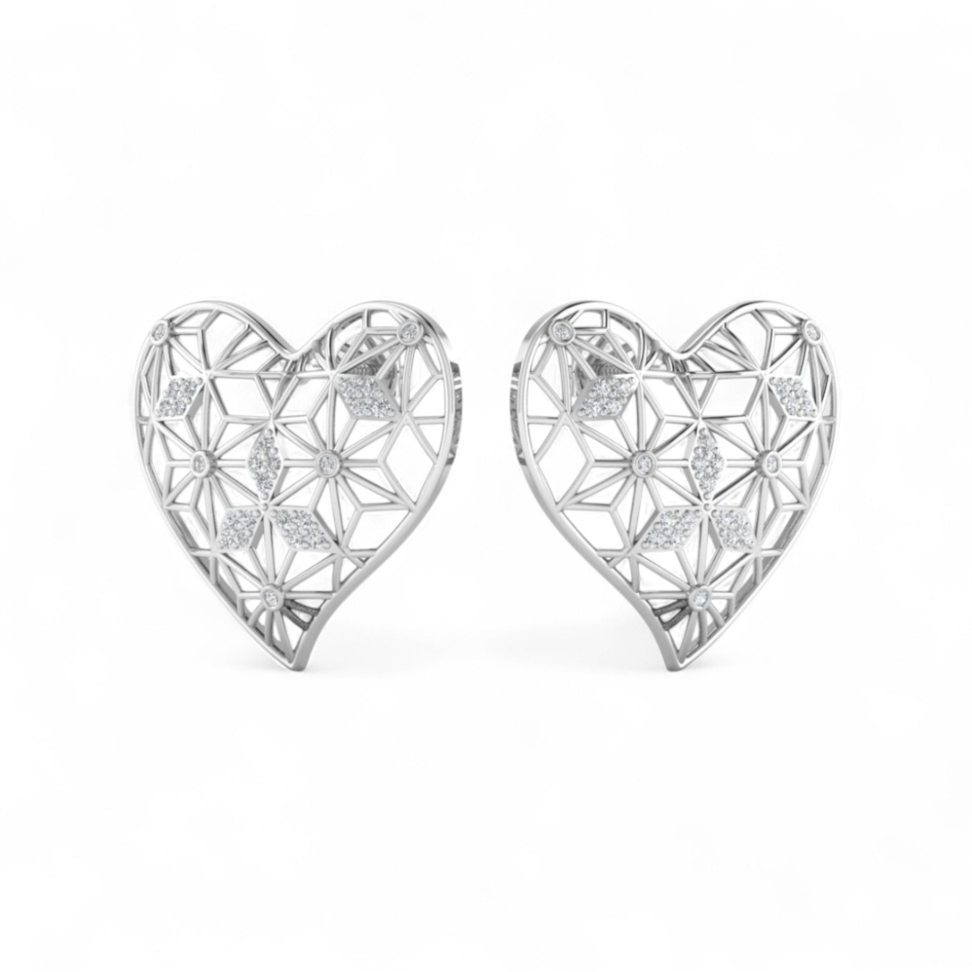 Heart-shaped silver earrings with intricate designs on a white background