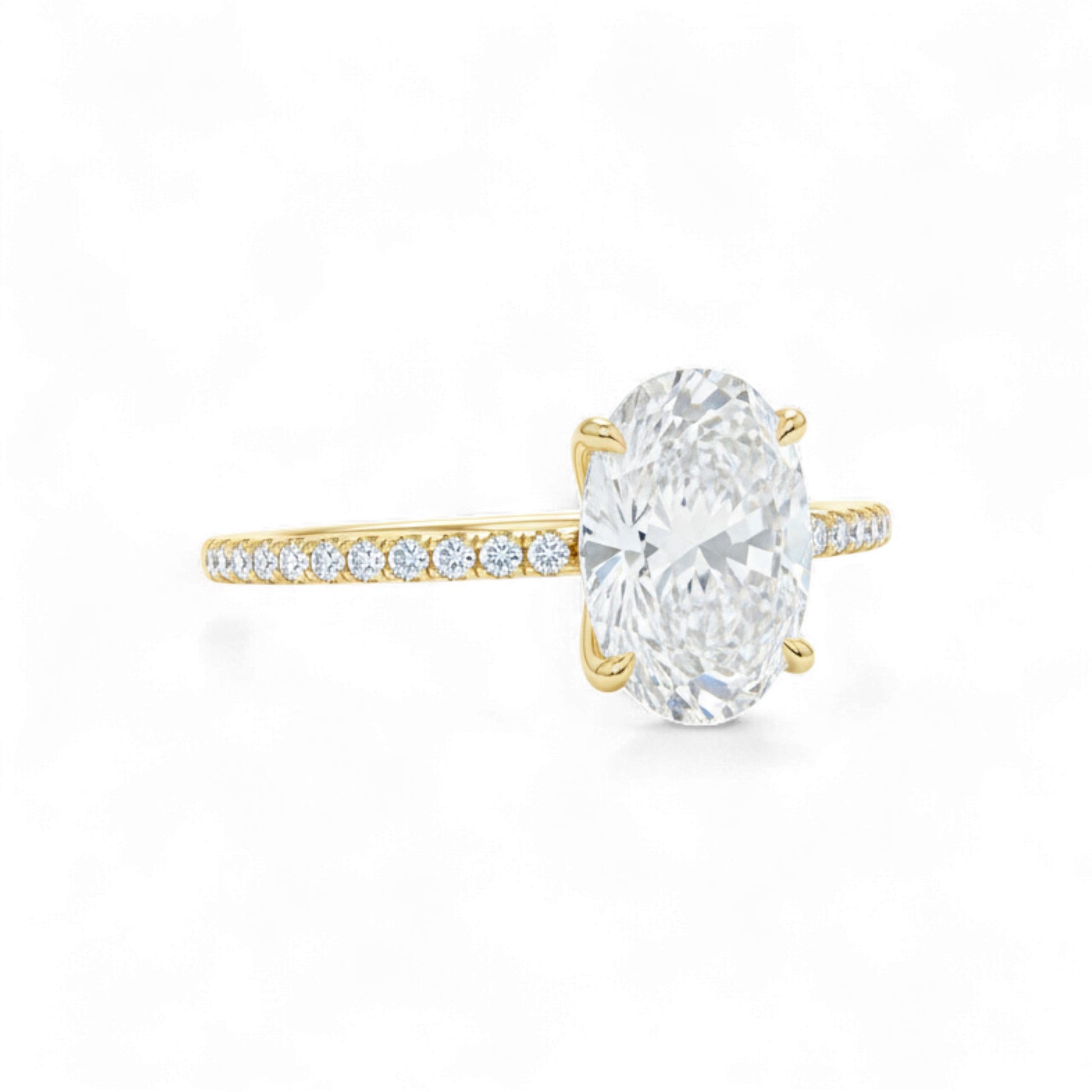 Gold ring with a large diamond and smaller diamonds on the band against a white background