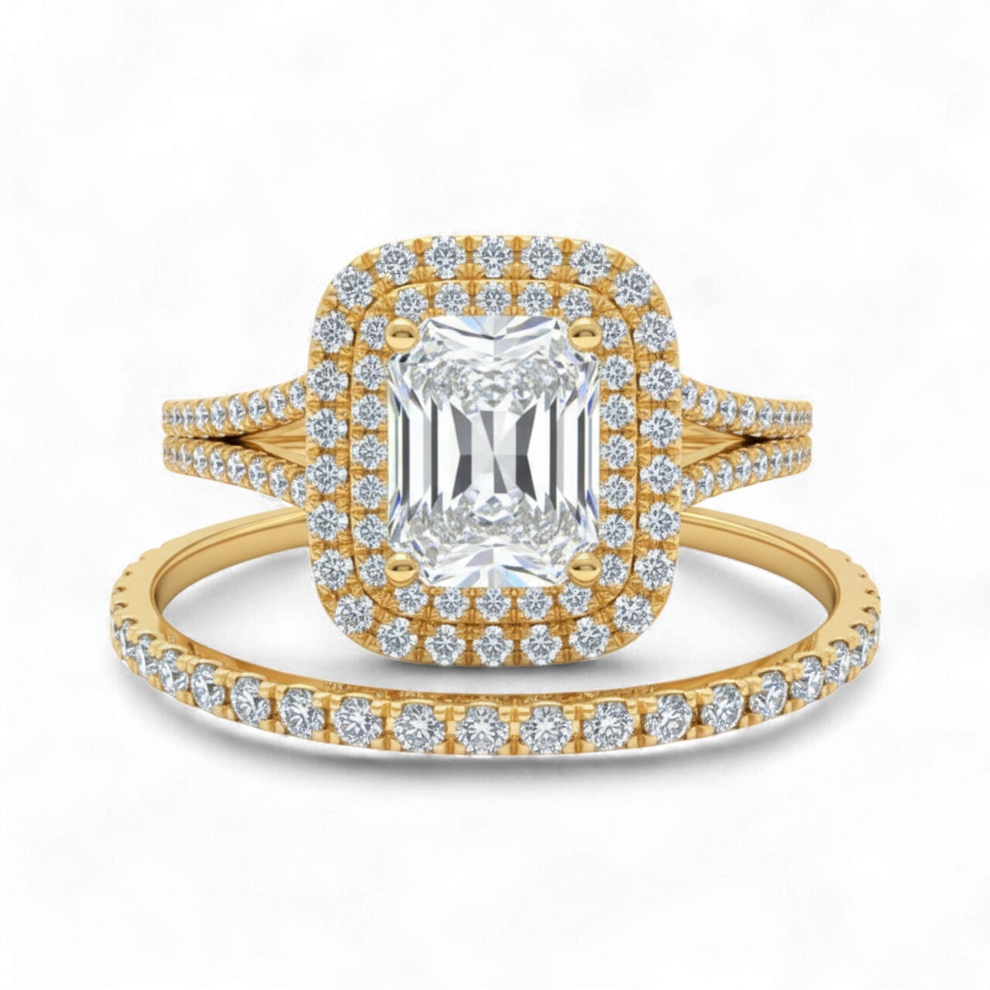 Gold ring with emerald-cut center stone and diamond halo on a white background