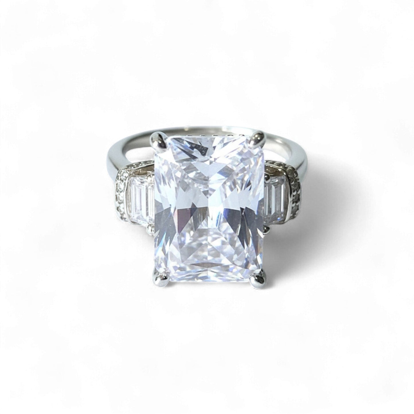 Diamond ring with a large central gemstone on a white background