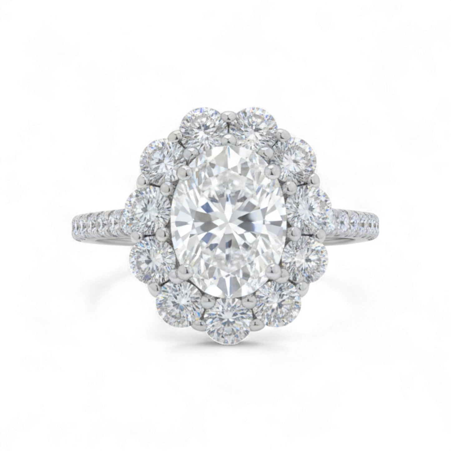 Diamond ring with a central gemstone and halo on a white background