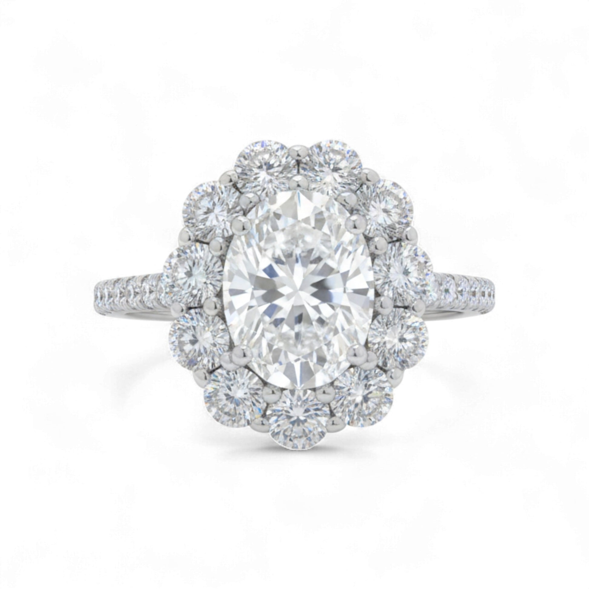 Diamond ring with a central gemstone and halo on a white background