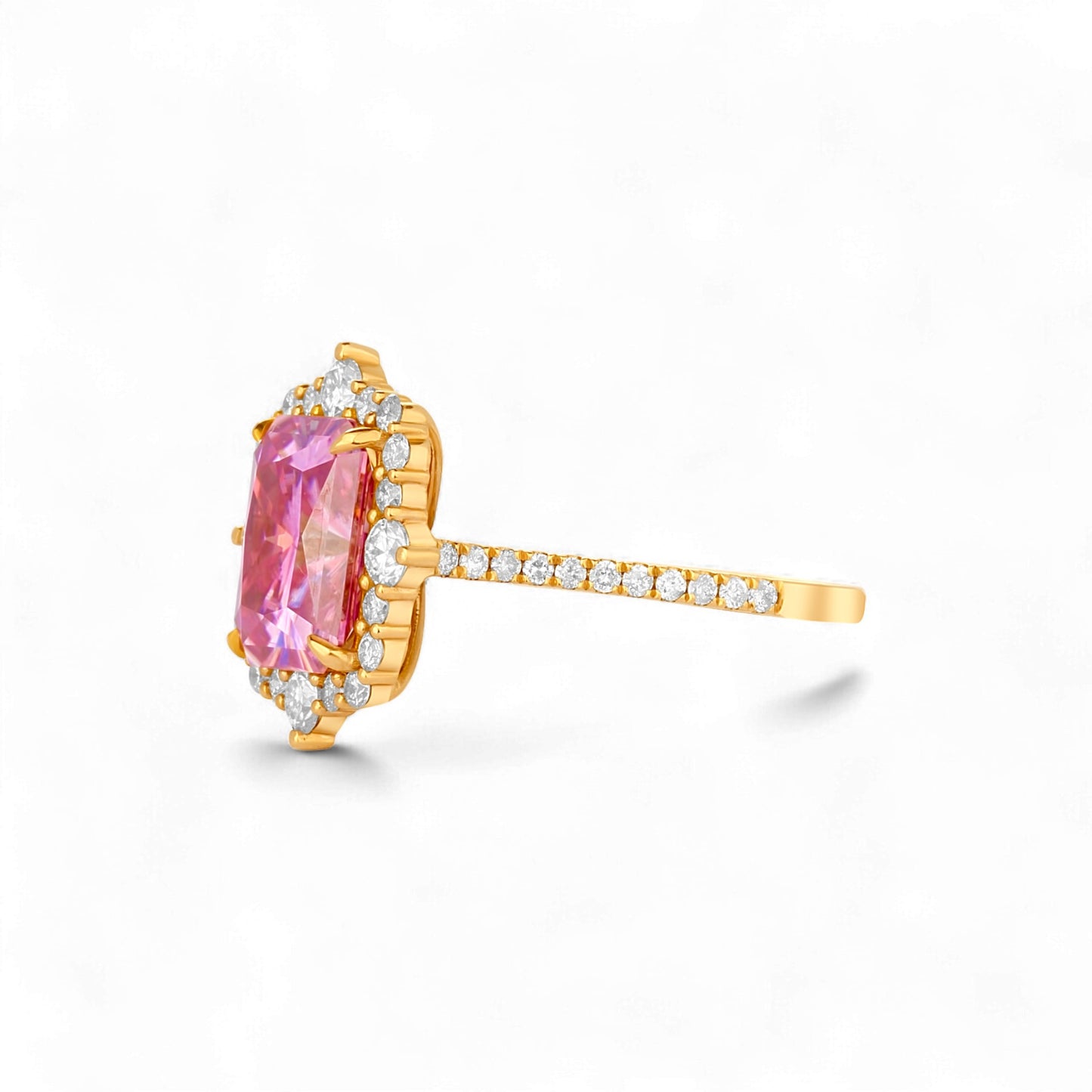Gold ring with a pink gemstone and diamond accents on a white background