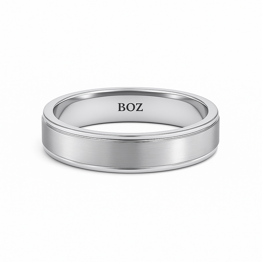 Silver ring with 'BOZ' engraving on a white background
