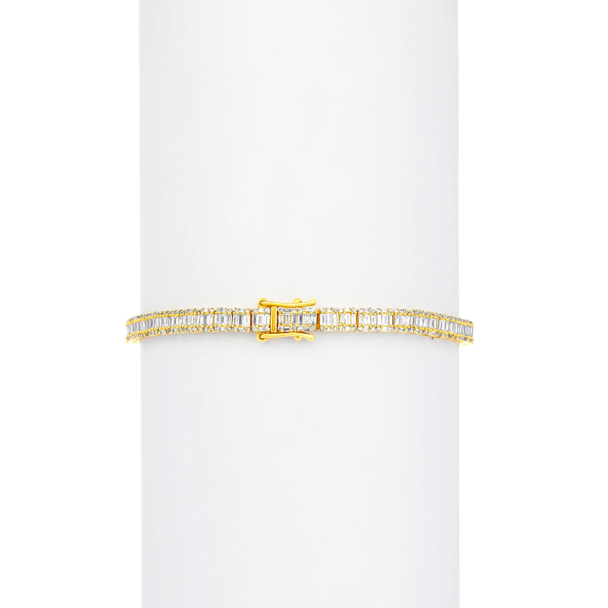 Gold bracelet with rectangular gemstones on a white background