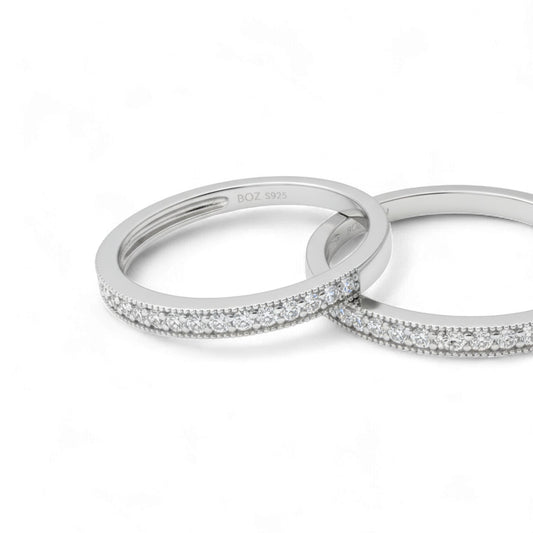 Two silver rings with diamond accents on a white background