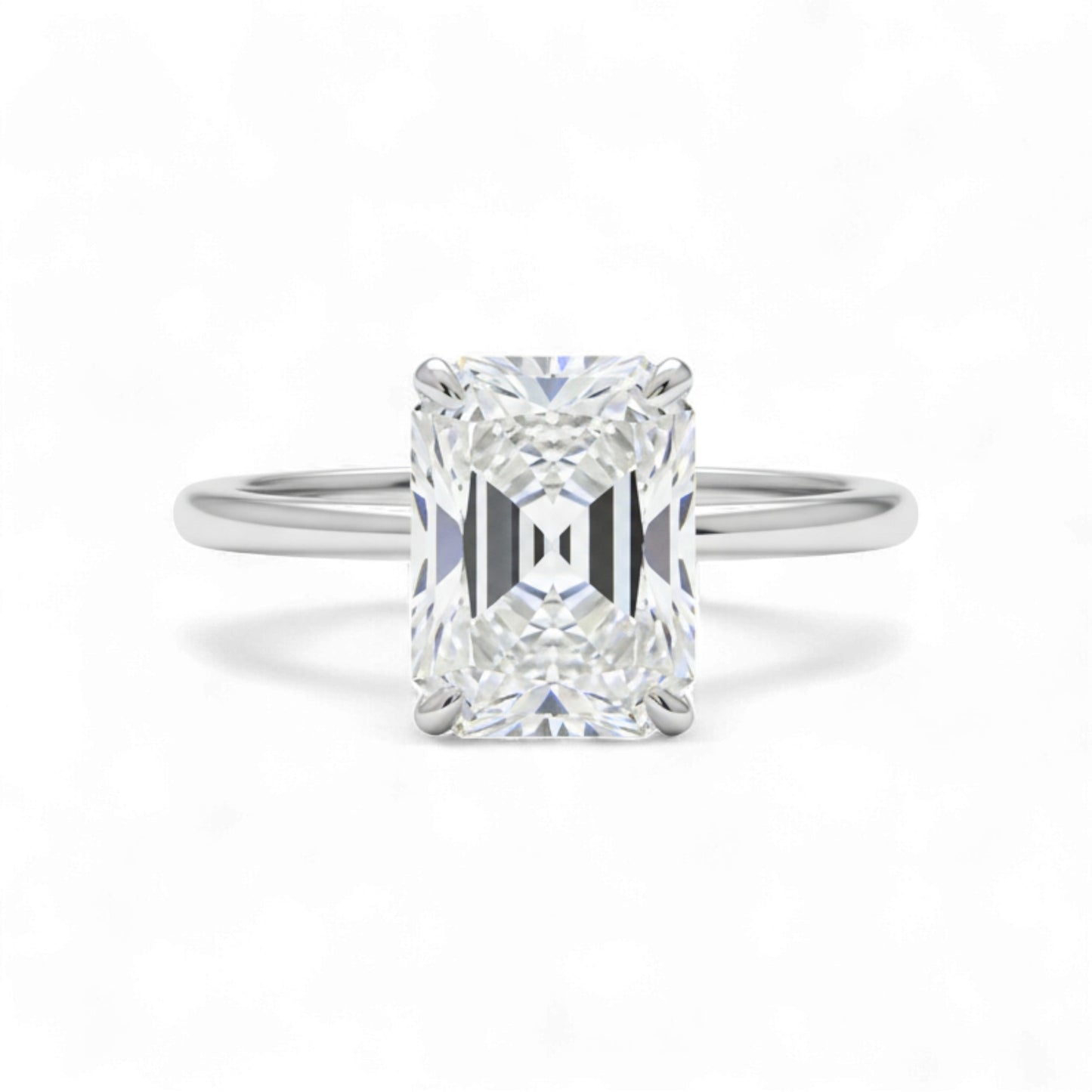 Diamond ring with a rectangular cut gemstone on a white background