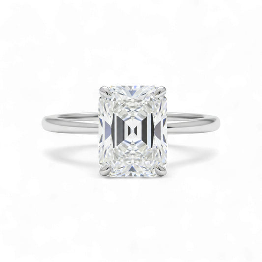 Diamond ring with a rectangular cut gemstone on a white background