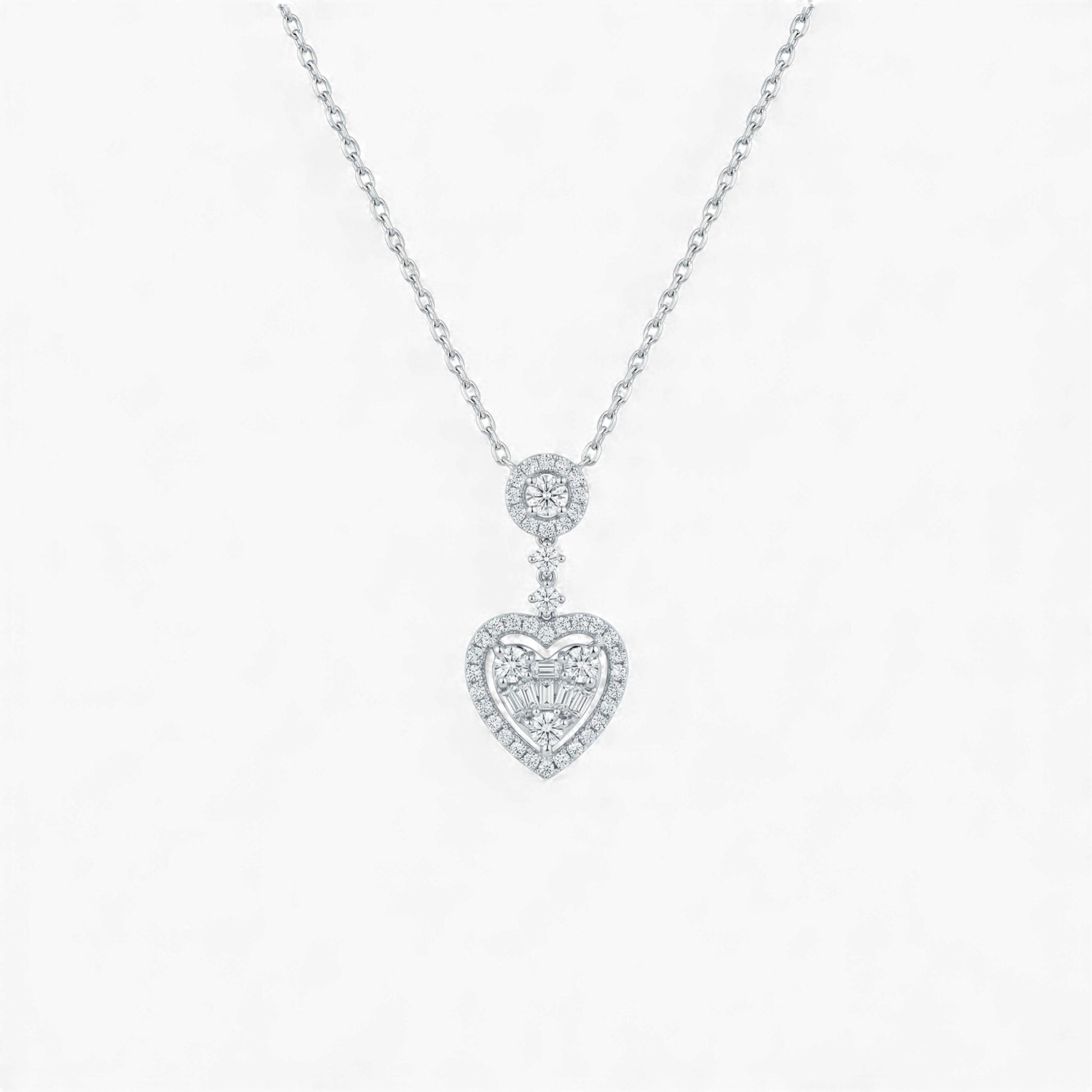 Heart-shaped diamond pendant on a chain against a white background