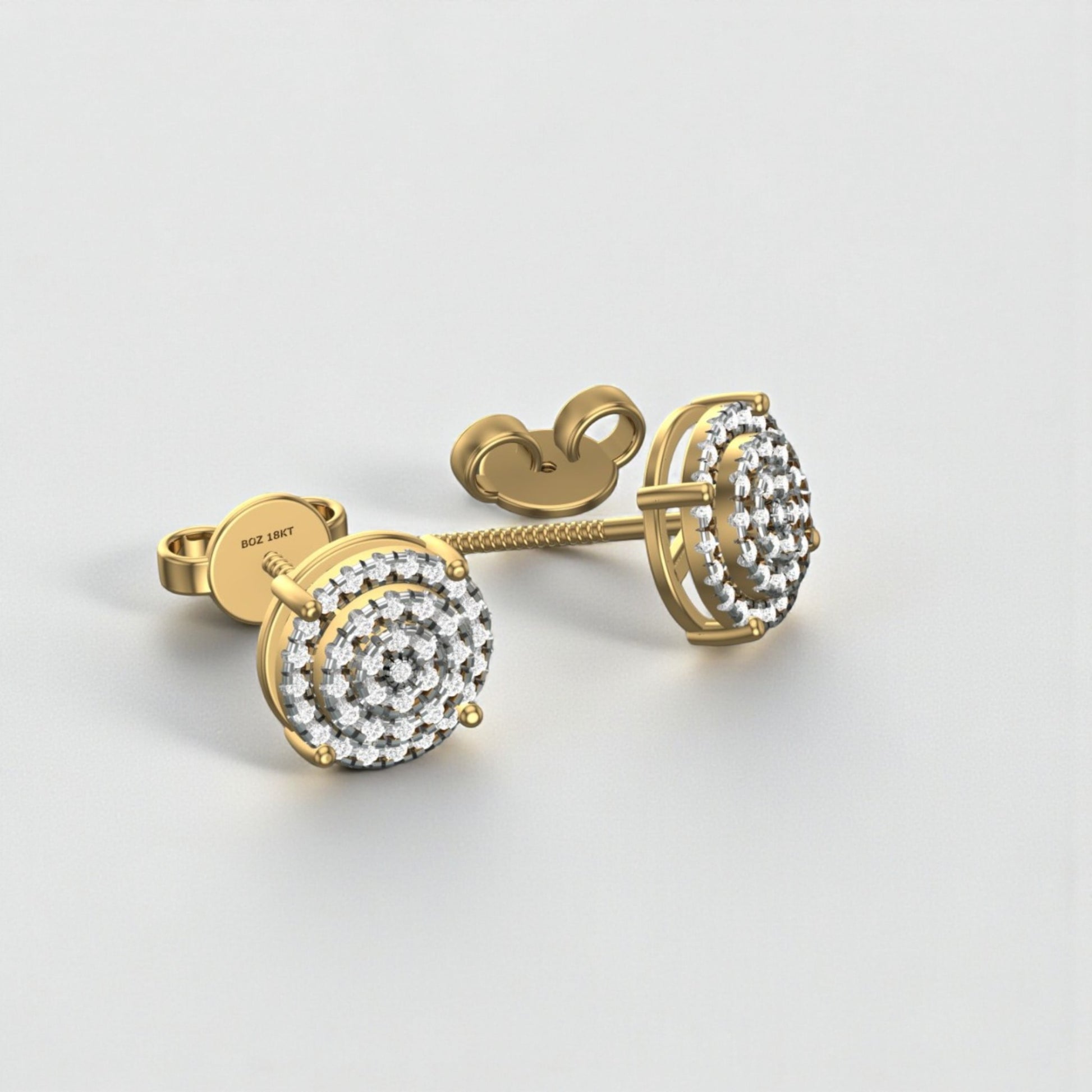 Gold earrings with clear gemstones on a light gray background