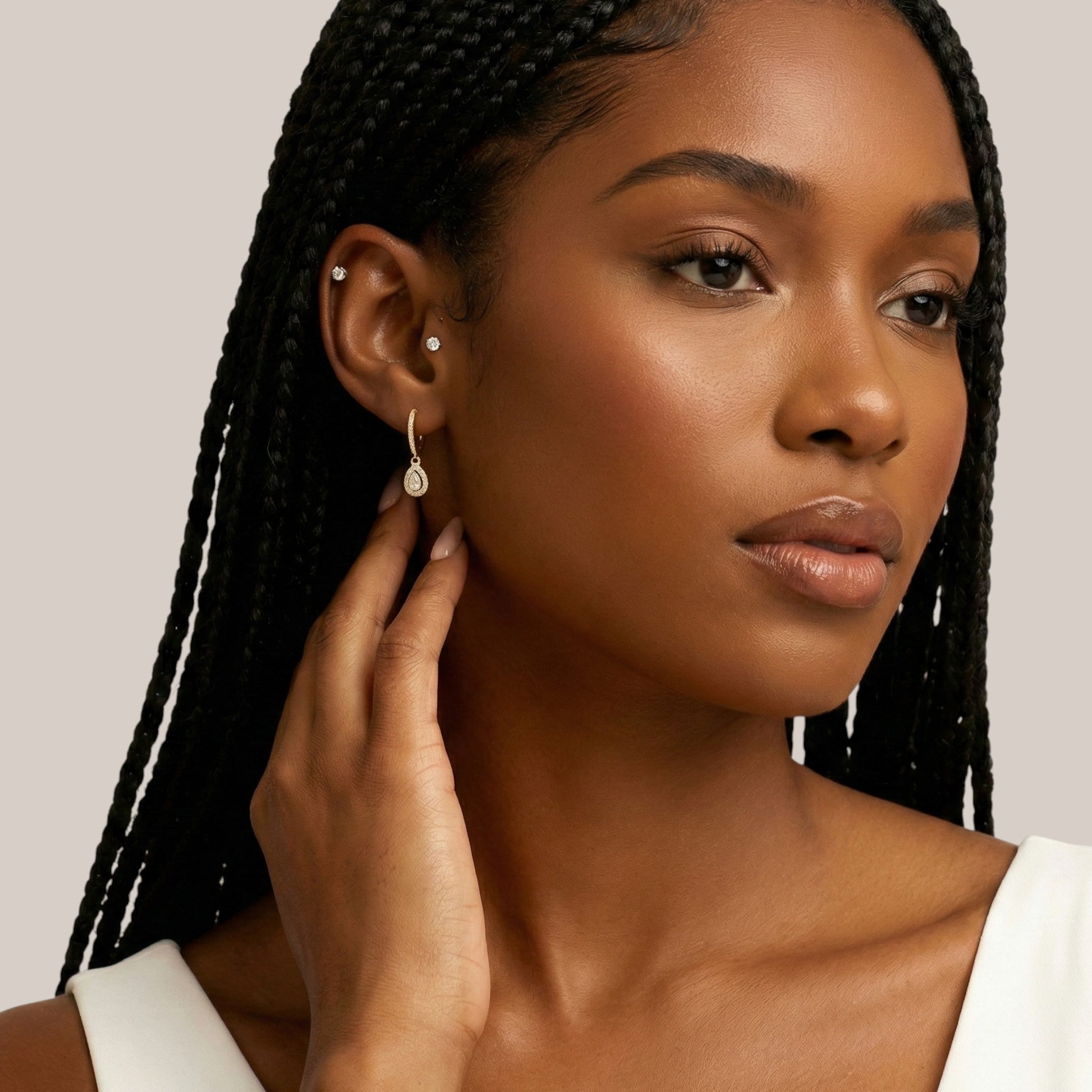 Woman wearing earrings with a neutral background