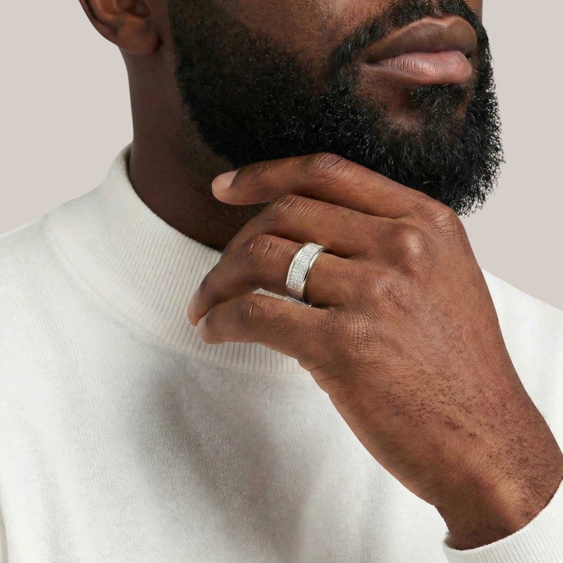 Close-up of a man wearing an Omoni Pavé Natural Diamond Band in 18KT gold on his finger