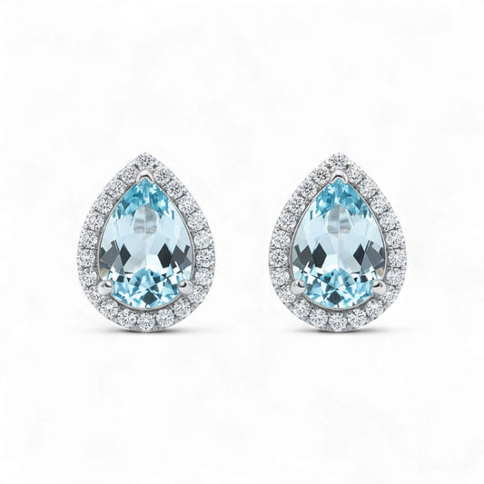Teardrop-shaped earrings with blue gemstones on a white background