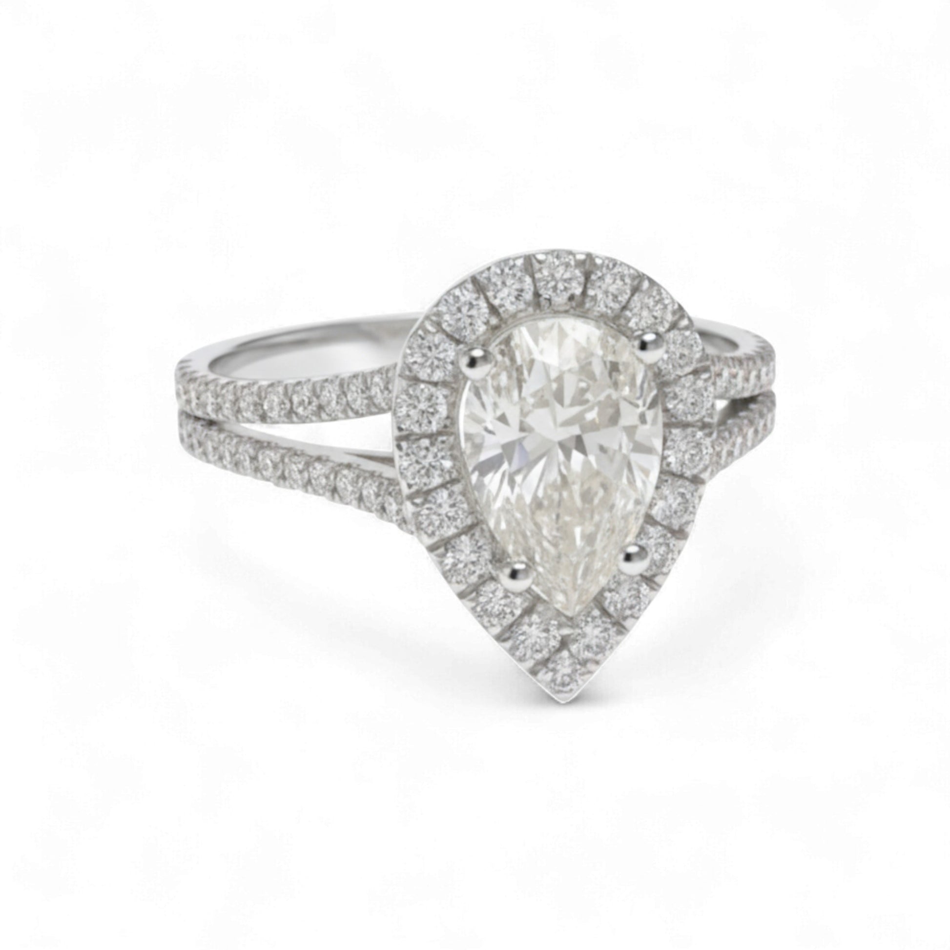 Diamond ring with pear-shaped center stone on a white background