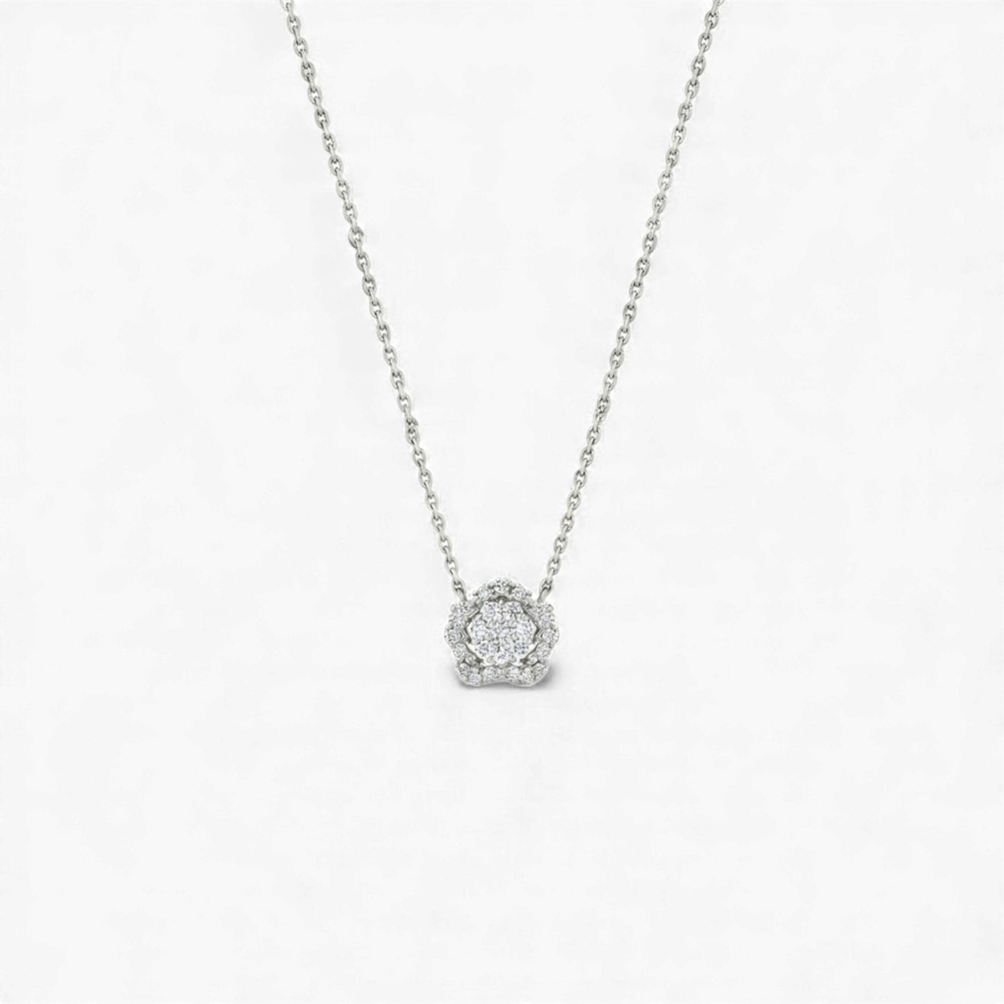 Silver necklace with a round pendant on a light gray background