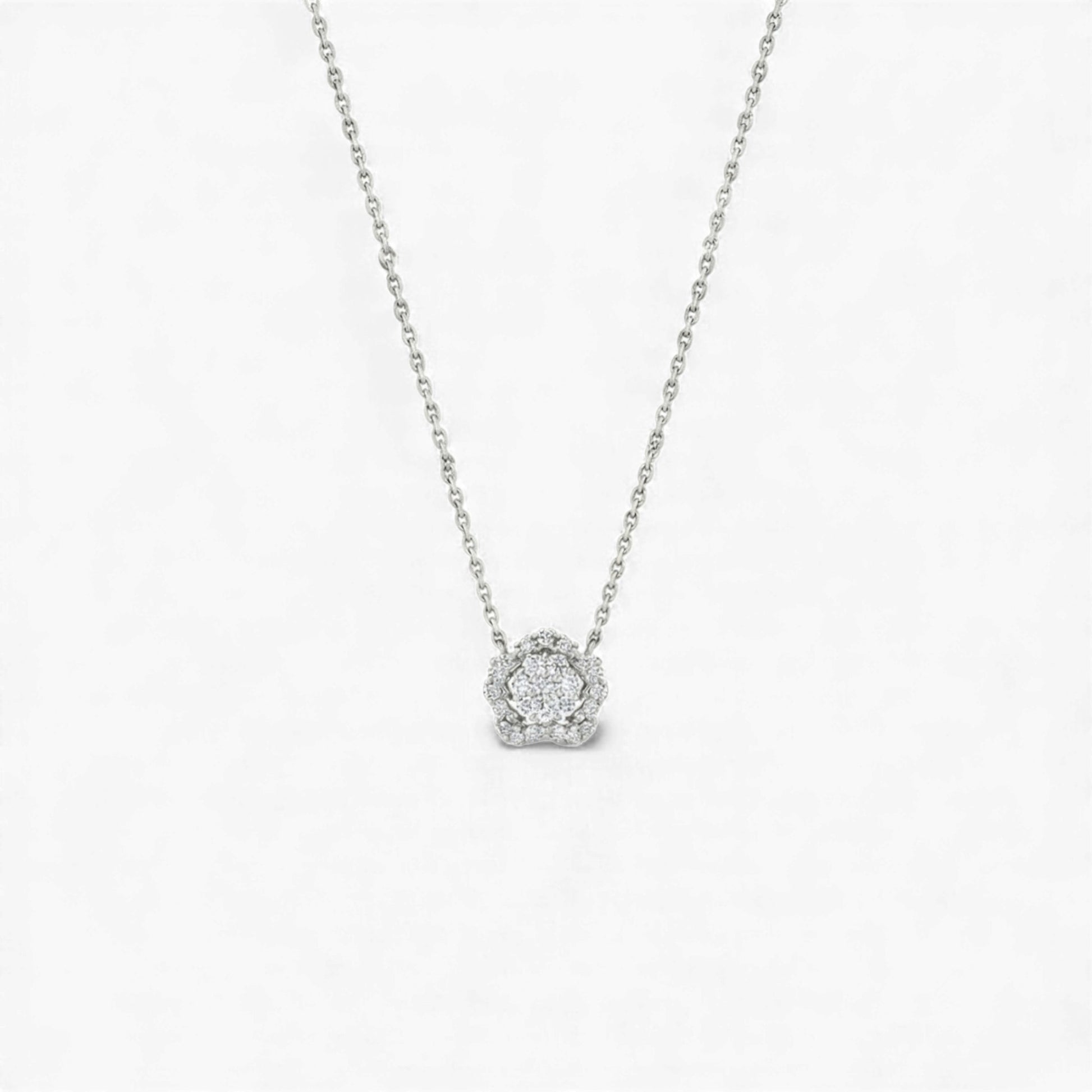 Silver necklace with a round pendant on a light gray background