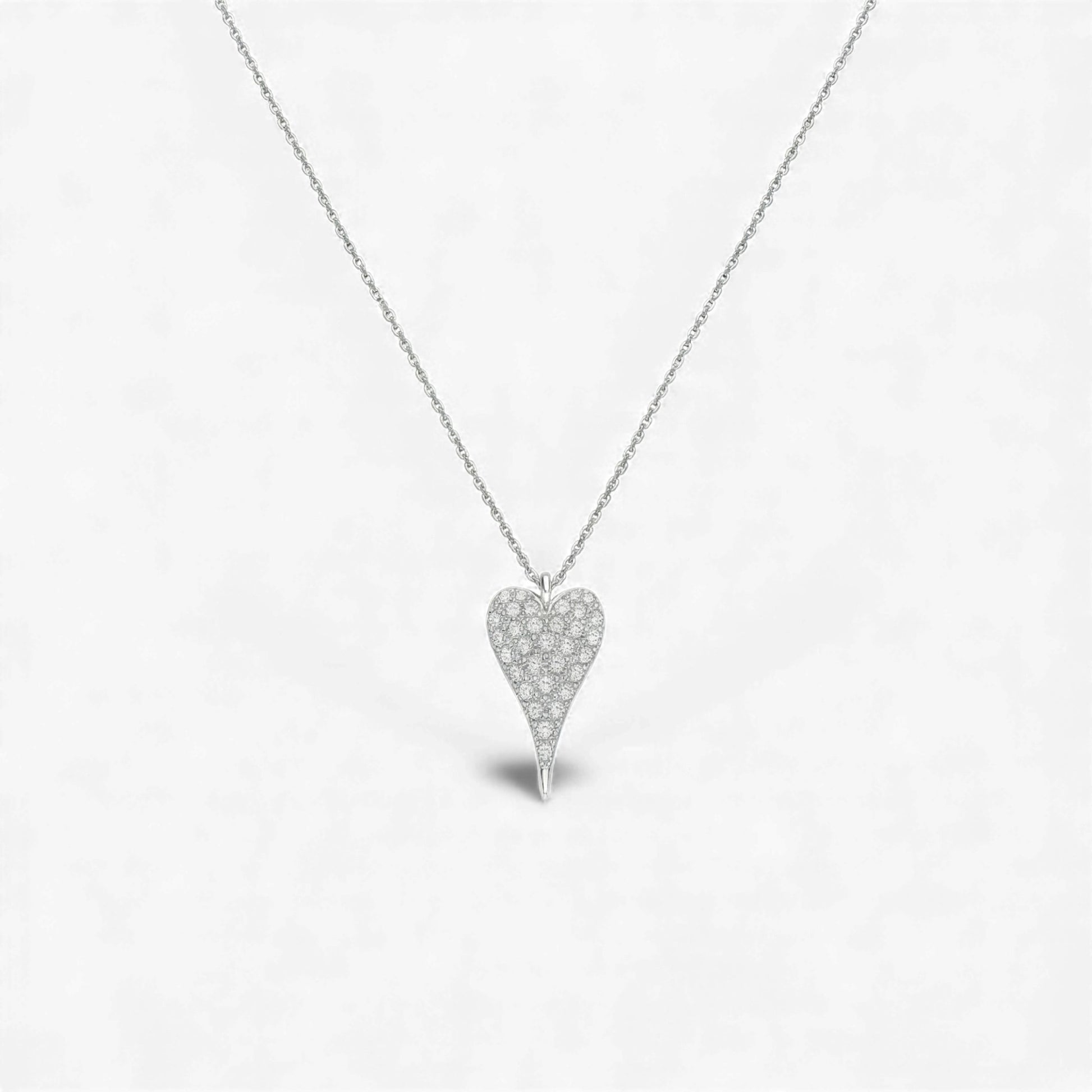 Heart-shaped diamond necklace on a light gray background