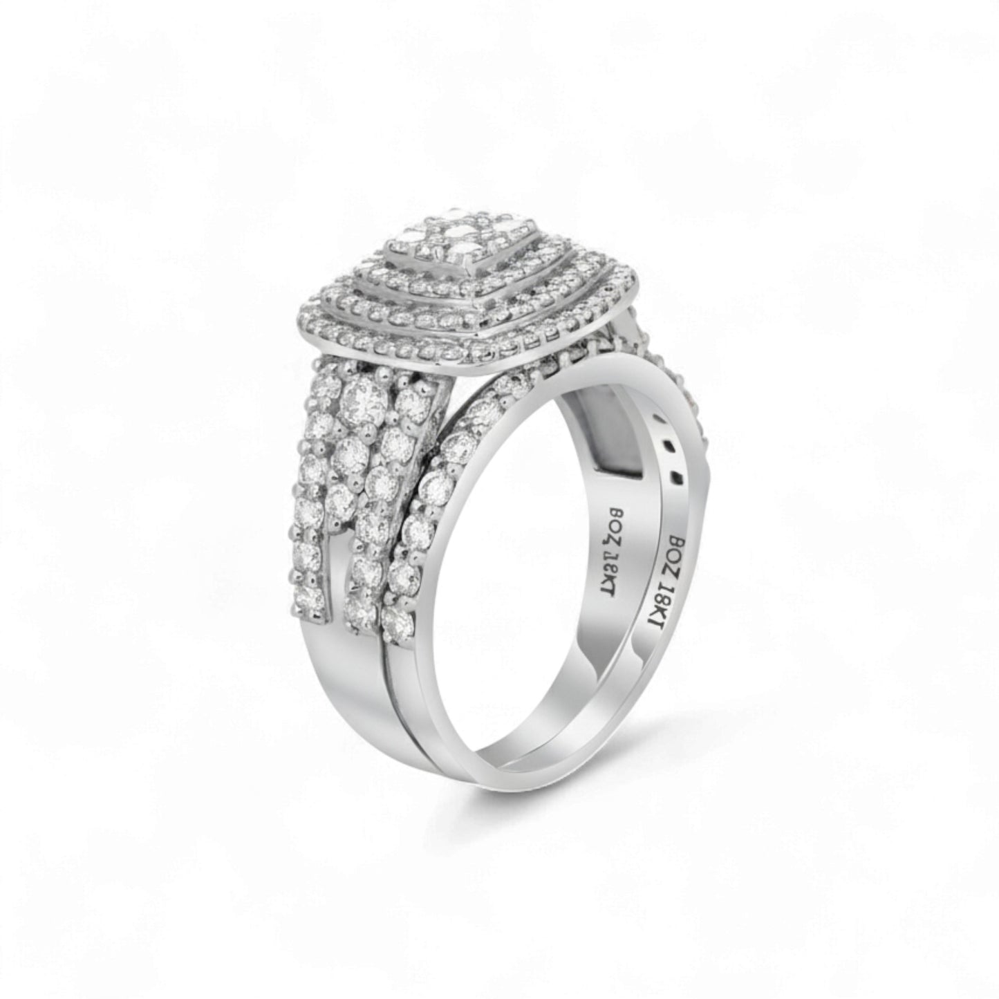Silver ring with intricate design on a white background