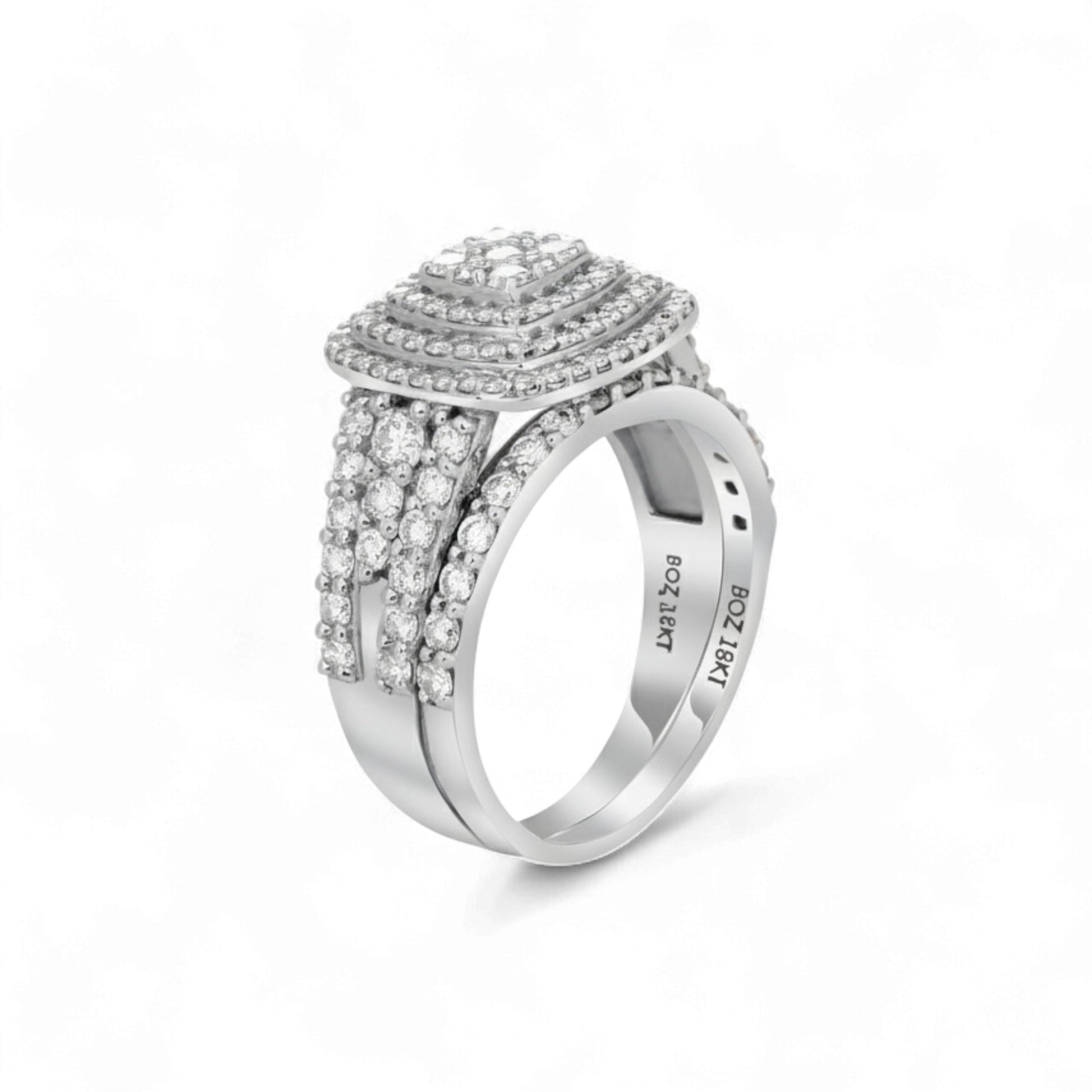 Silver ring with intricate design on a white background