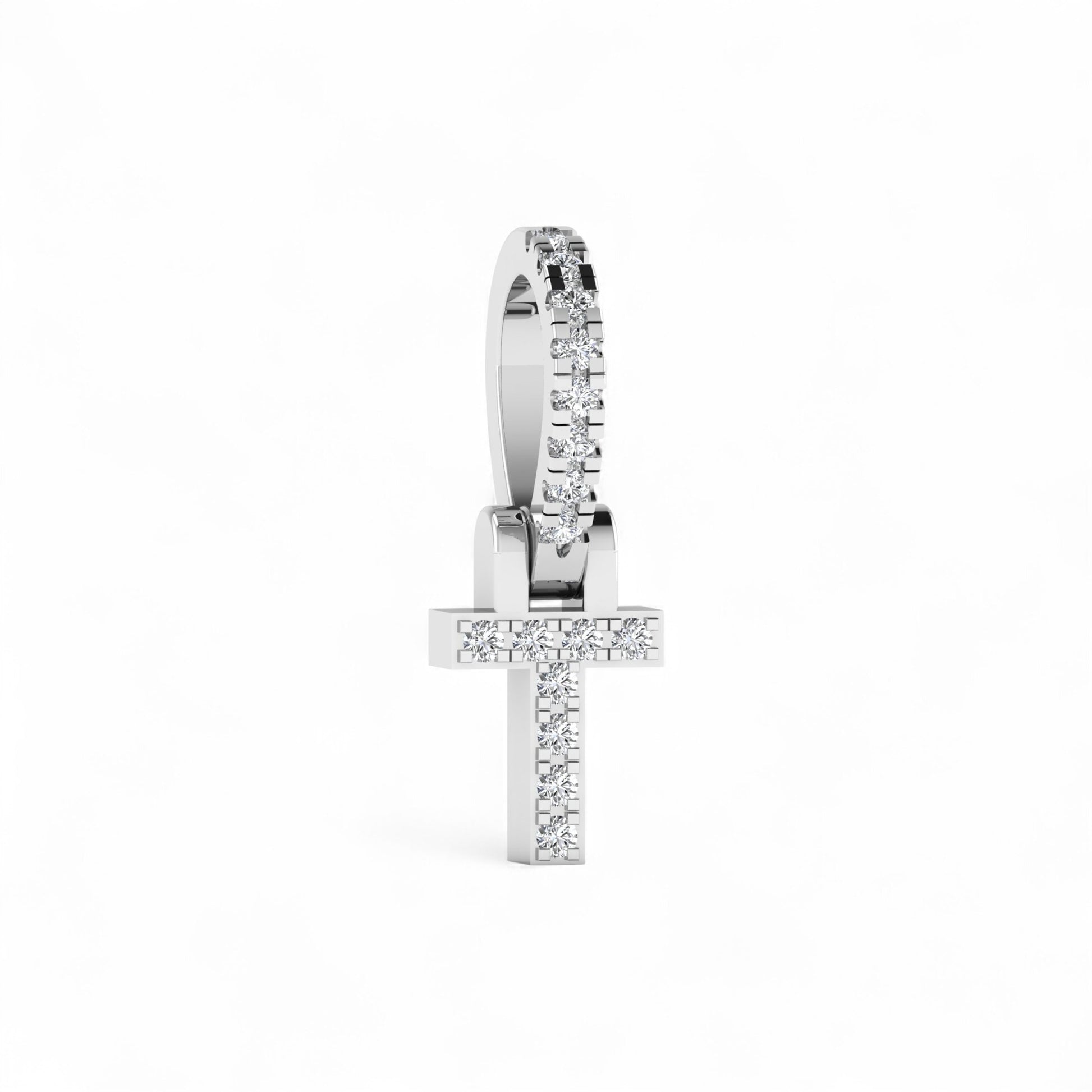 Silver cross-shaped earring with clear stones on a white background