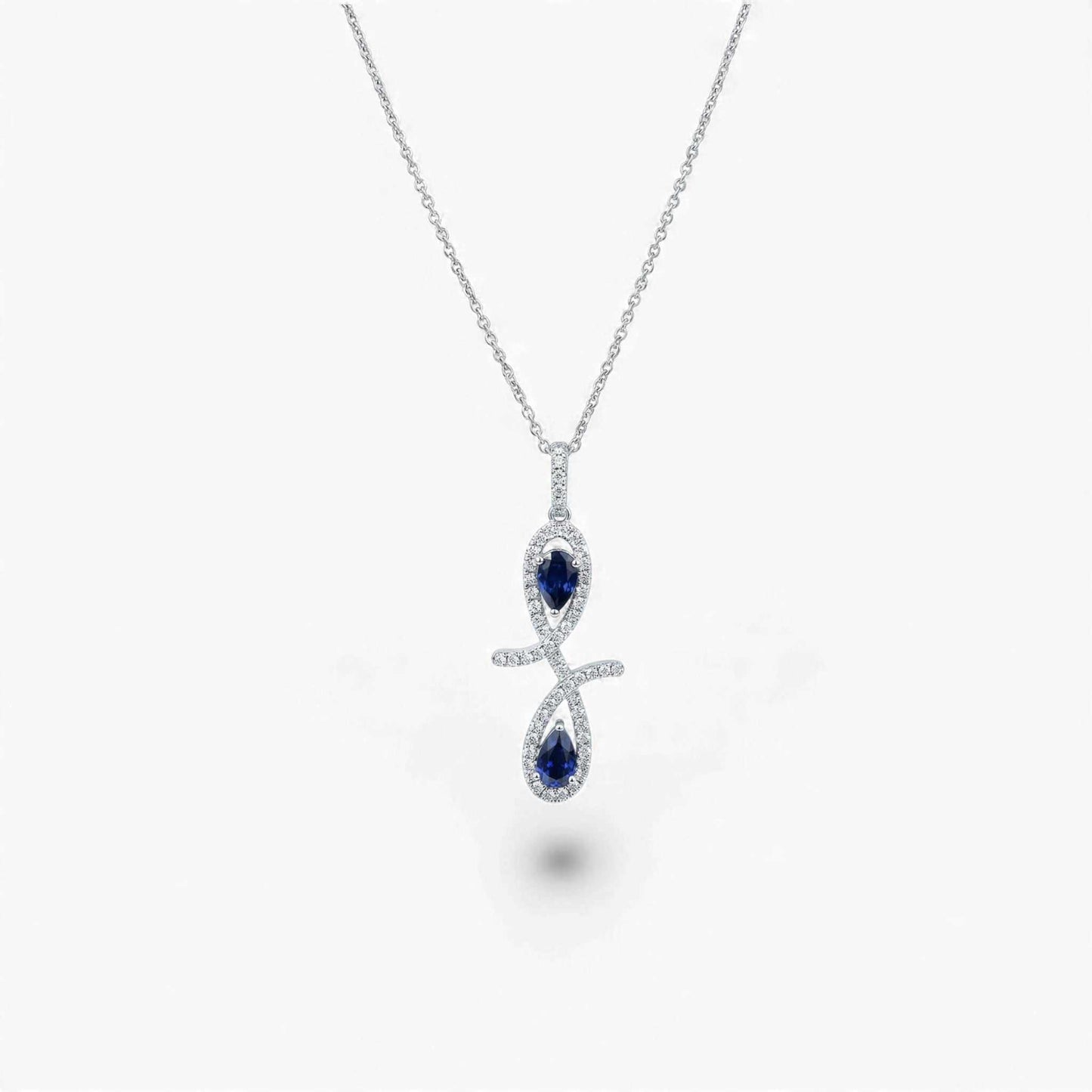 Silver necklace with a blue gemstone pendant on a white background