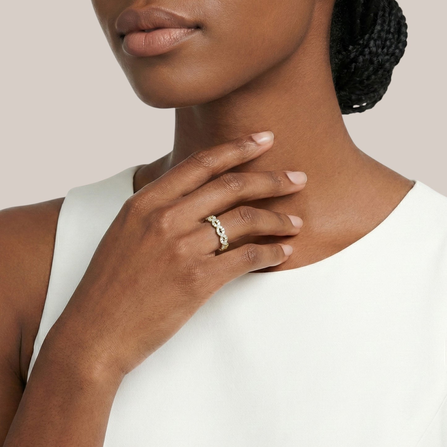 Woman wearing a ring on her hand with a neutral background