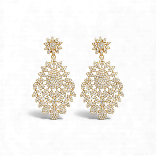 Pair of gold earrings with intricate designs on a white background
