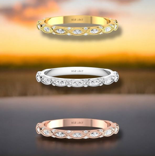 Three gold rings displayed on a platform with branding visible.