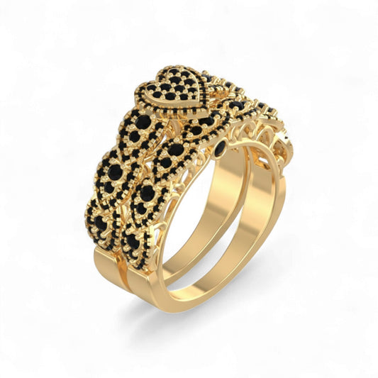 Gold ring with black gemstones on a white background