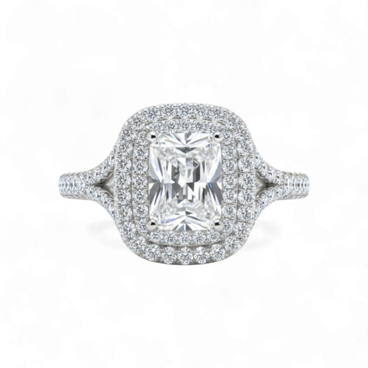 Diamond ring with a central gemstone and halo on a white background