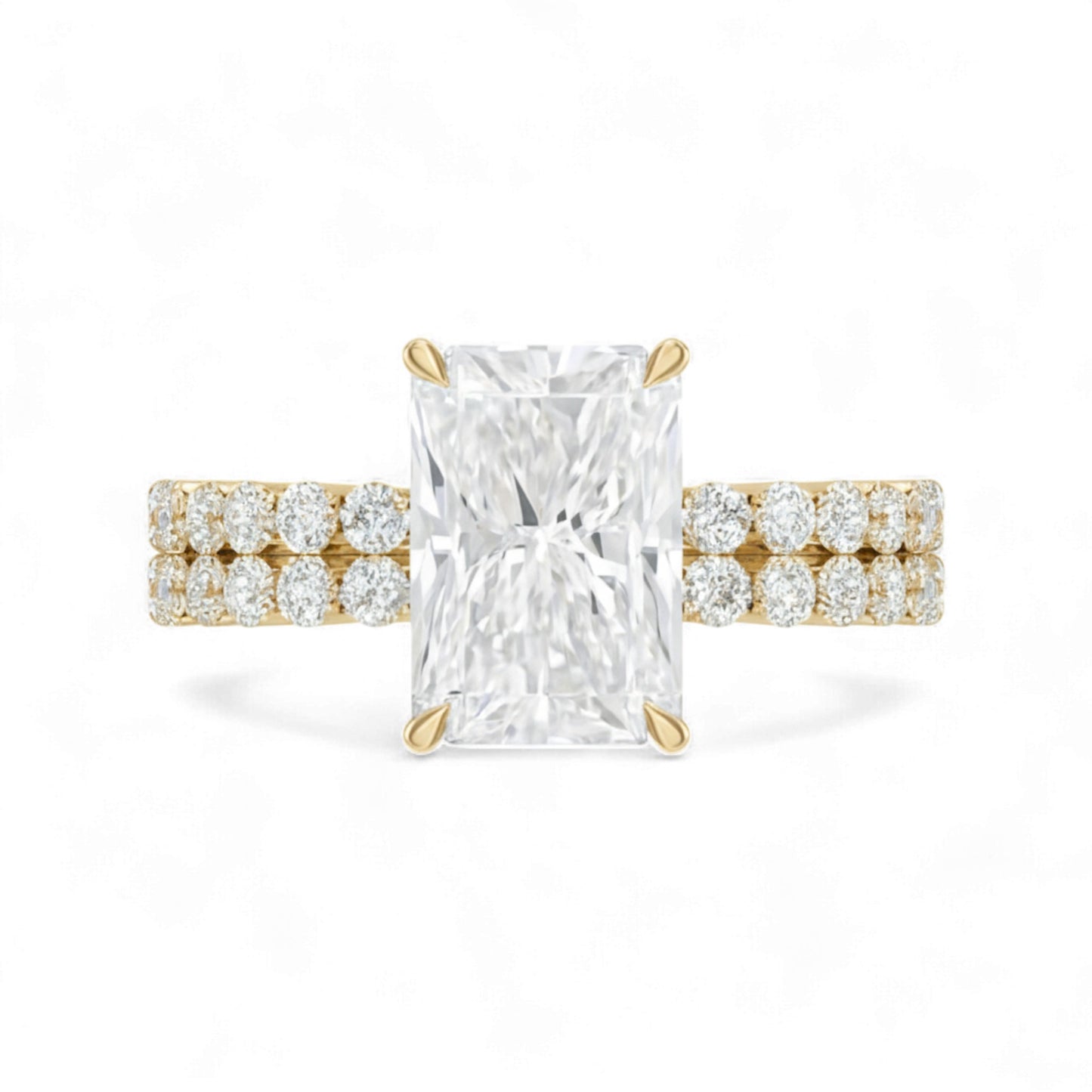 Gold ring with a large diamond and smaller diamonds on the band against a white background