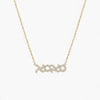Gold necklace with 'xoxo' pendant on a white background