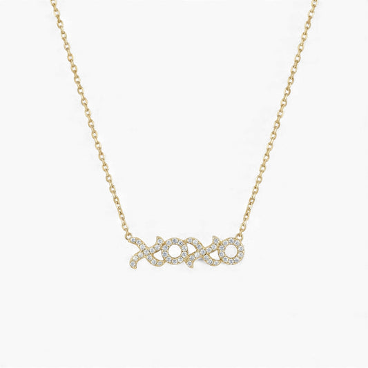 Gold necklace with 'xoxo' pendant on a white background