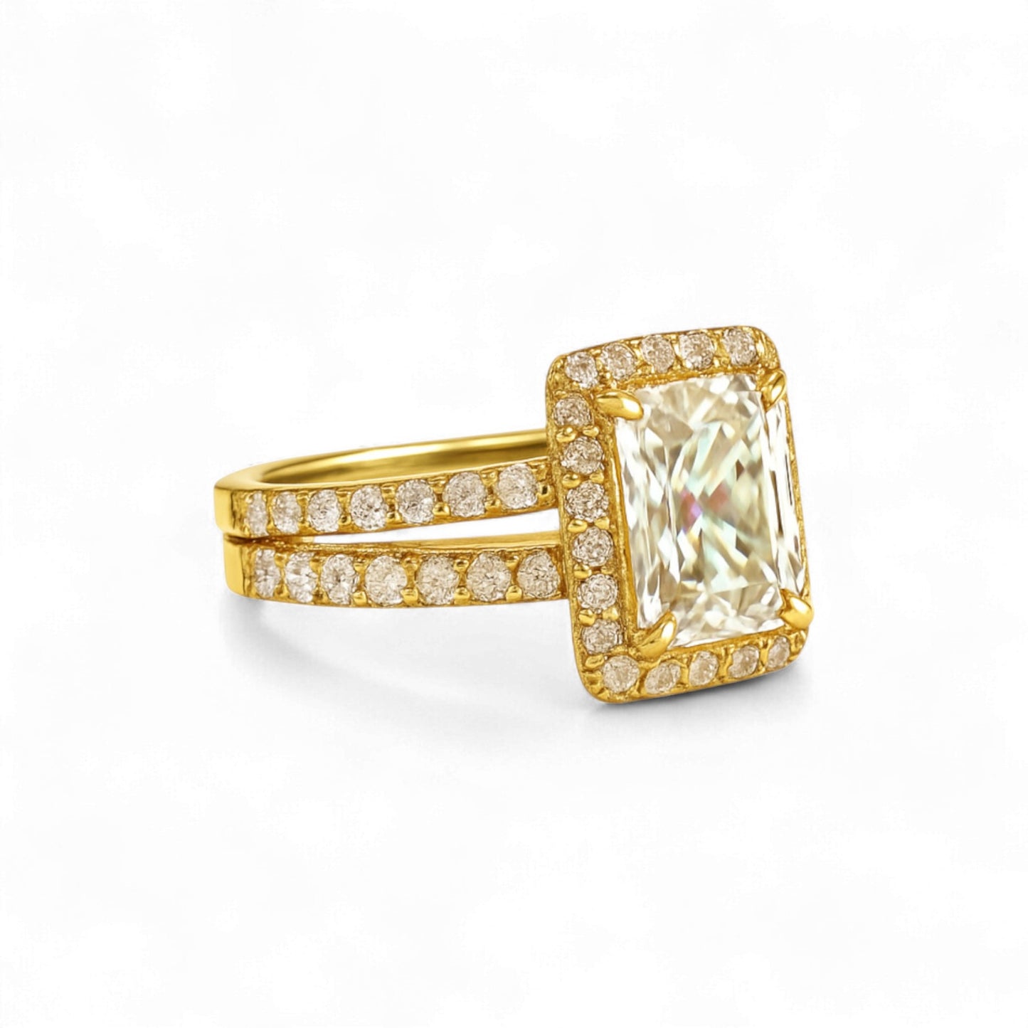 Gold ring with a large diamond and smaller diamonds on the band against a white background