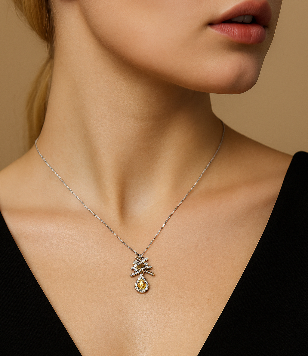 Close-up of a woman wearing a necklace with a pendant against a neutral background